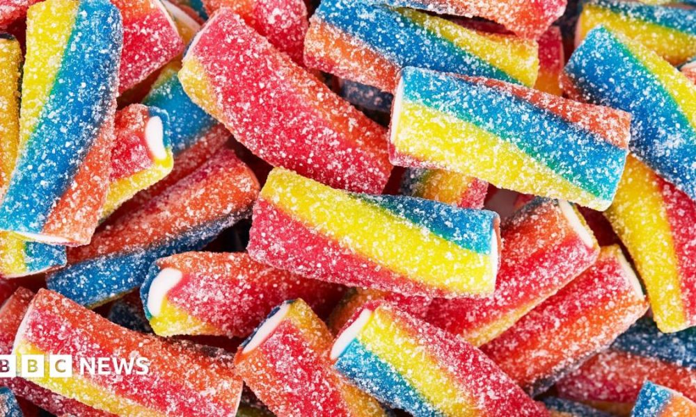 Rainbow sour jelly candy covered in sugar sprinkles