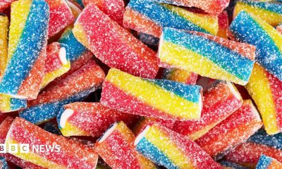 Rainbow sour jelly candy covered in sugar sprinkles