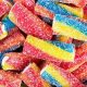 Rainbow sour jelly candy covered in sugar sprinkles