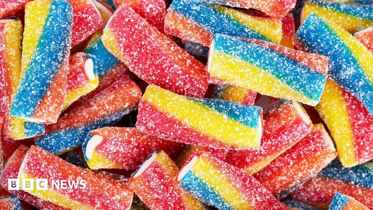 Rainbow sour jelly candy covered in sugar sprinkles
