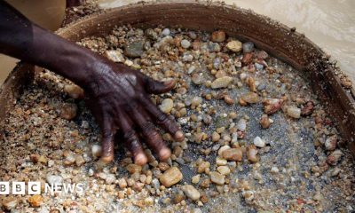 The hand of a diamond miner in Sierra Leone has he sieves gravel and smaller stones in the hope of finding the precious gems