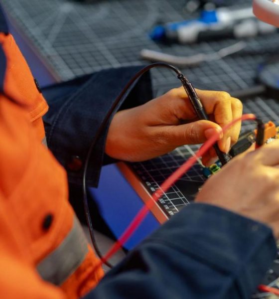 A female worker testing a circuit board in a workshop
