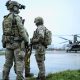 British special forces on a runway with a helicopter nearby