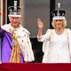 King Charles and Queen Camilla on the Buckingham Palace balcony wearing crowns and robes