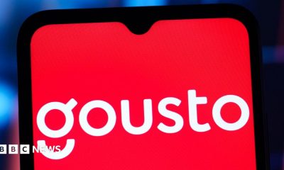 The white Gousto logo on a red background on a mobile phone