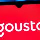 The white Gousto logo on a red background on a mobile phone