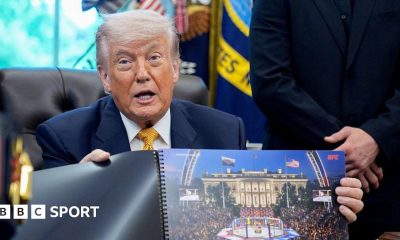 Donald Trump hols up a rendered image of the UFC's White House event