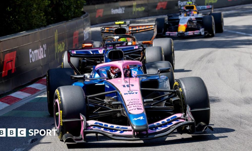 Alpine's Pierre Gasly with McLaren's Lando Norris right behind him, and a Racing Bulls in the background, approaching the hairpin during the Monaco Grand Prix