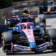 Alpine's Pierre Gasly with McLaren's Lando Norris right behind him, and a Racing Bulls in the background, approaching the hairpin during the Monaco Grand Prix