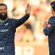Yorkshire player Moeen Ali smiles and holds up his hand in celebration as he is approached by team-mate Dom Bess.