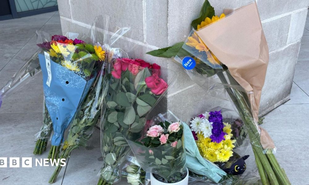Flowers left at the entrance to a flat.