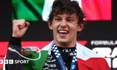 Kimi Antonelli with the Italian flag draped around his shoulders after winning the Monaco Grand Prix