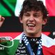 Kimi Antonelli with the Italian flag draped around his shoulders after winning the Monaco Grand Prix