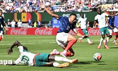 Senegal's Sadio Mane challenges France's Kylian Mbappe in the penalty area leading to a VAR review