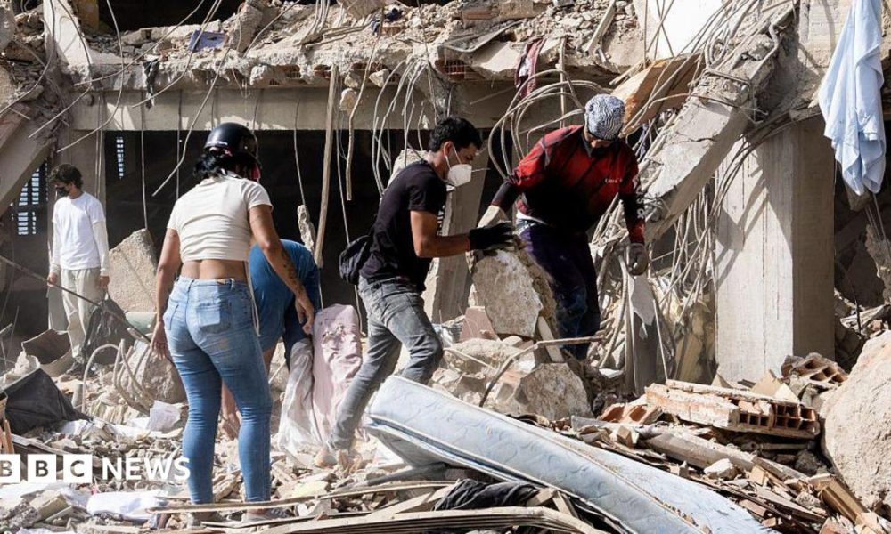 Family members and volunteers search through the rubble after two 17-story buildings in the Belo Horizonte residential complex collapsed in Catia La Mar, La Guaira (Venezuela), on June 26, 2026.