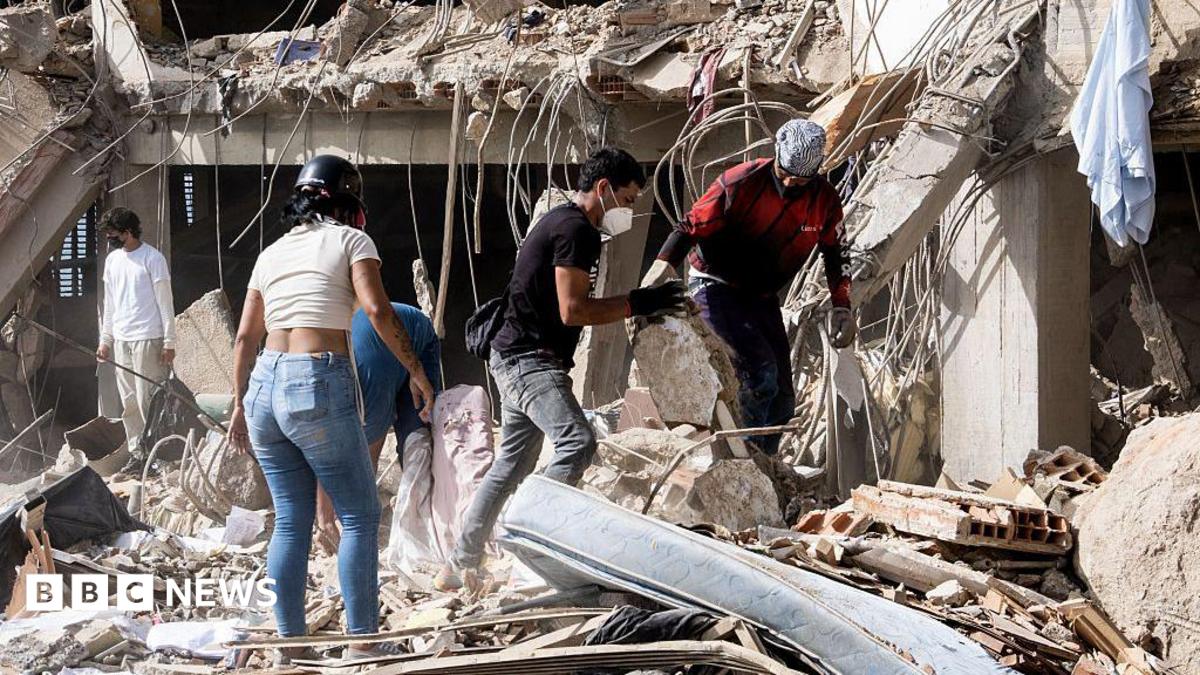 Family members and volunteers search through the rubble after two 17-story buildings in the Belo Horizonte residential complex collapsed in Catia La Mar, La Guaira (Venezuela), on June 26, 2026.