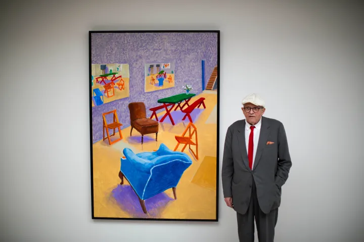 David Hockney posing with one of his art pieces in 2015