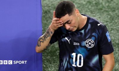 Miguel Almiron walks off the pitch holding his head after being sent off