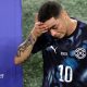 Miguel Almiron walks off the pitch holding his head after being sent off