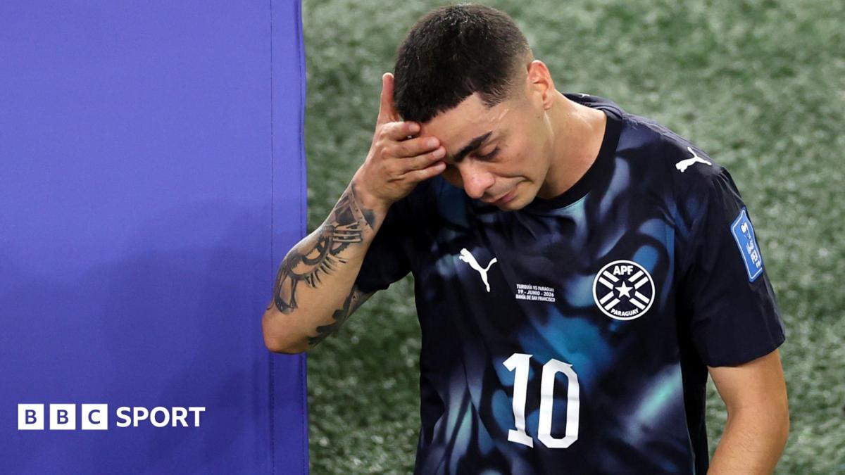 Miguel Almiron walks off the pitch holding his head after being sent off