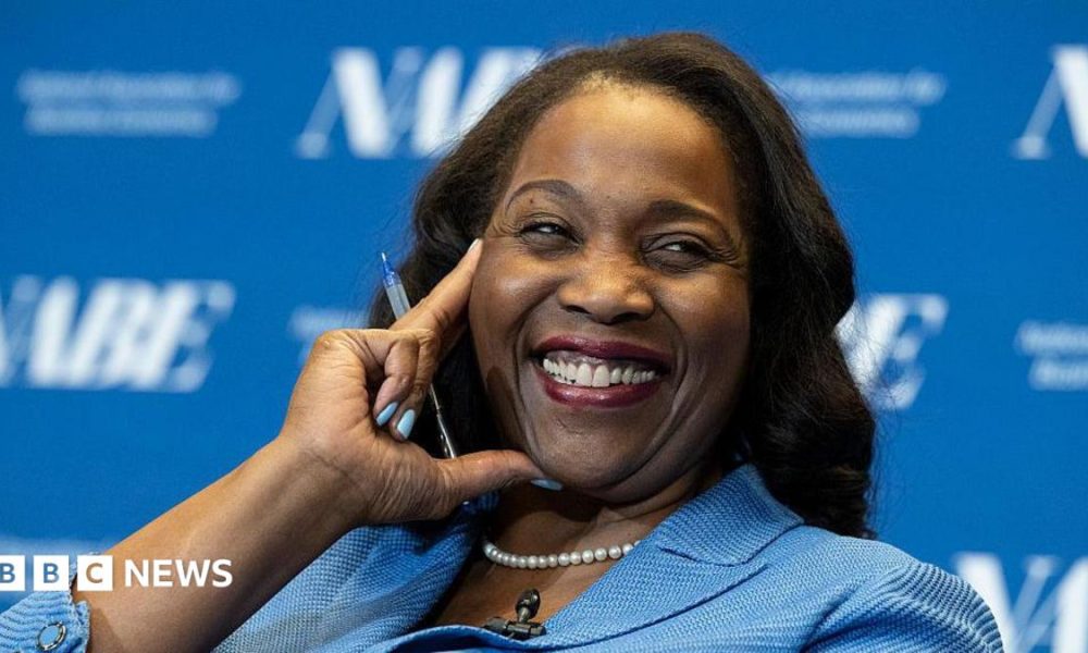 Lisa D. Cook, a member of the Board of Governors of the Federal Reserve, smiles while holding her hand against her face. She is wearing a blue suit and speaks at The Capital Hilton during the 42nd annual National Association for Business Economics Economic Policy Conference on February 24, 2026 in Washington, DC.