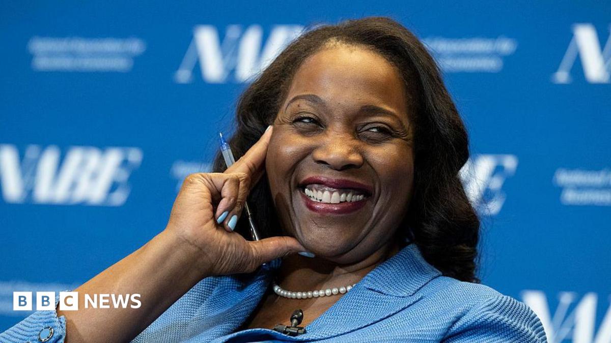 Lisa D. Cook, a member of the Board of Governors of the Federal Reserve, smiles while holding her hand against her face. She is wearing a blue suit and speaks at The Capital Hilton during the 42nd annual National Association for Business Economics Economic Policy Conference on February 24, 2026 in Washington, DC.