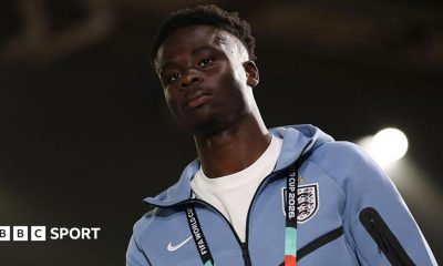 Bukayo Saka in a pale blue England tracksuit