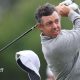 Rory McIlroy's cap flies off on the 13th hole
