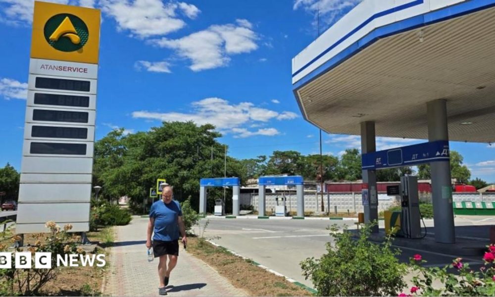 A man walks past an empty gas station after local authorities in Crimea suspended petrol sales to the public and businesses due to a fuel crisis caused by Ukrainian attacks on its supply routes,