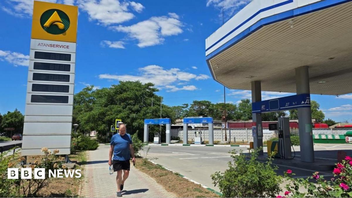 A man walks past an empty gas station after local authorities in Crimea suspended petrol sales to the public and businesses due to a fuel crisis caused by Ukrainian attacks on its supply routes,