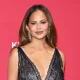Chrissy Teigen Reveals Surgical Scar in Low Cut Dress Boobies Out