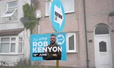 A Reform UK placard of their by-election candidate Robert Kenyon stands outside a terraced home on 3 June 2026 in Ashton-in-Makerfield, England