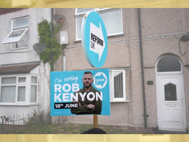 A Reform UK placard of their by-election candidate Robert Kenyon stands outside a terraced home on 3 June 2026 in Ashton-in-Makerfield, England