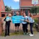 Reform councillors standing next to a man holding a sign which reads 'I would rather vote for Jimmy Saville than Labour'