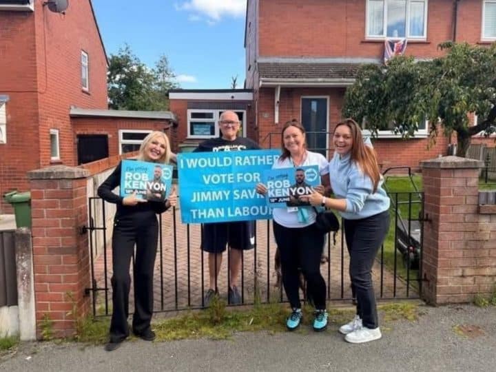 Reform councillors standing next to a man holding a sign which reads 'I would rather vote for Jimmy Saville than Labour'
