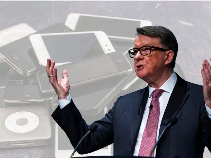 Peter Mandelson in front of pictures of mobile devices