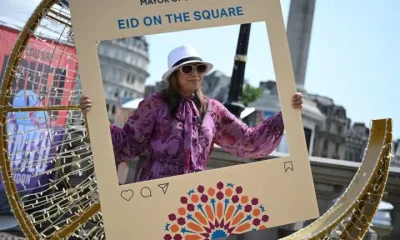 A festival goer poses in a photo frame at Eid on the Square 2026