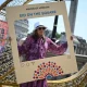 A festival goer poses in a photo frame at Eid on the Square 2026