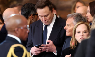 Elon Musk checks phone