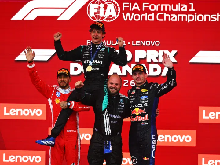 MONTREAL, QUEBEC - MAY 24: Race winner Andrea Kimi Antonelli of Italy and Mercedes AMG Petronas F1 Team Second placed Lewis Hamilton of Great Britain and Scuderia Ferrari Third placed Max Verstappen of the Netherlands and Oracle Red Bull Racing and Dean Hale, Senior Race Team Composite Technician at Mercedes AMG Petronas F1 Team on the podium during the F1 Grand Prix of Canada at Circuit Gilles-Villeneuve on May 24, 2026 in Montreal, Quebec. (Photo by Rudy Carezzevoli/Getty Images) Formula 1