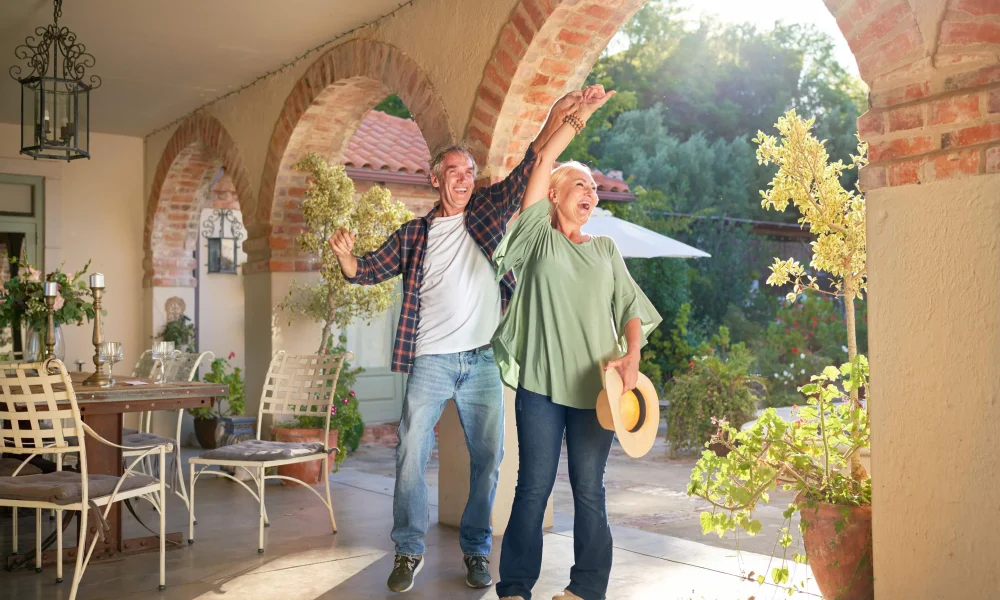 Over 50's couple enjoying holiday in the sun after booking their travel insurance.