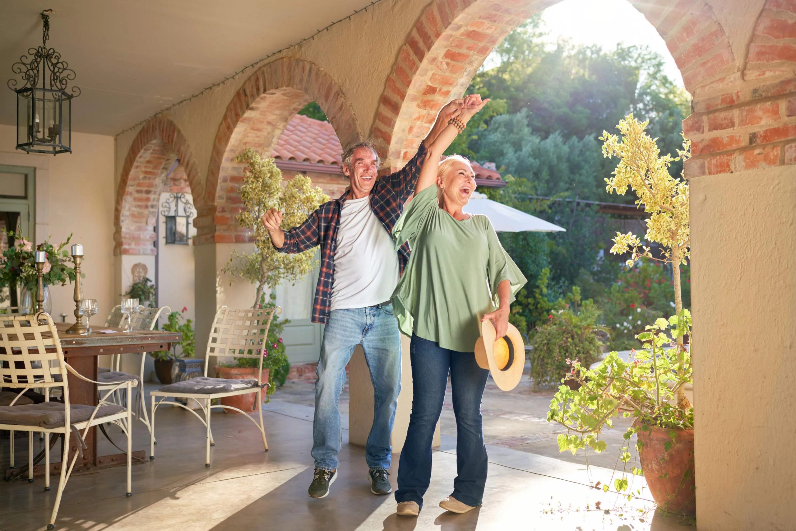 Over 50's couple enjoying holiday in the sun after booking their travel insurance.