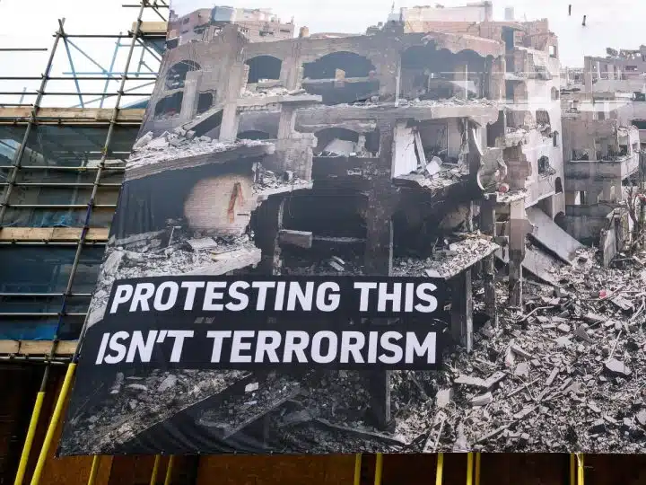 Huge banner shows destruction in Gaza and says: Protesting This Isn't Terrorism Palestine Action