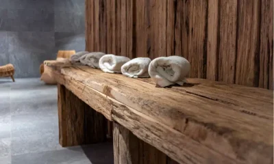 Folded Beige Towels Ready for Use in Spa on Rustic Wooden Table