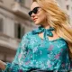 Beautiful blonde mature woman using her smart phone on the street in Barcelona in Spain.