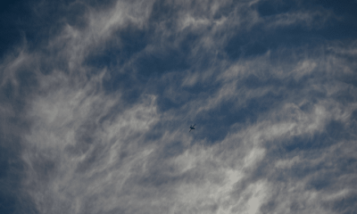 An Israeli air-force single isolated drone in the distance with partly cloudy background. This is not a photo of Israel's AI killer drones in the story.