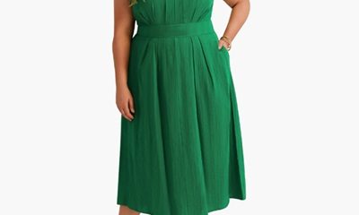 A woman wearing a plus-size green maxi dress with nude heels