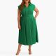 A woman wearing a plus-size green maxi dress with nude heels
