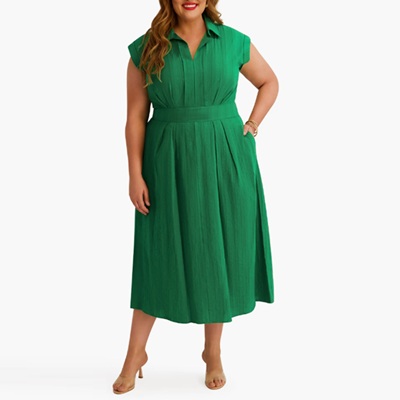 A woman wearing a plus-size green maxi dress with nude heels