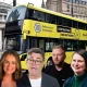 Composite image of Restore, Labour, Reform and Green candidates for Makerfield by-election in front of a Bee Network bus. Illustrating questions of candidates on public ownership